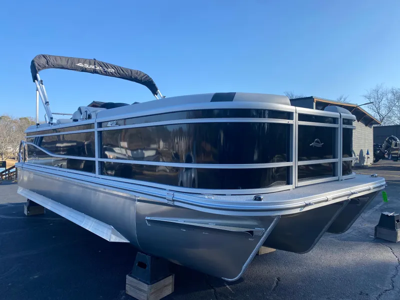 Slide: The Image of 2025 SunCatcher Select 322RC pontoon boat on display, featuring sleek black and silver design. - 1