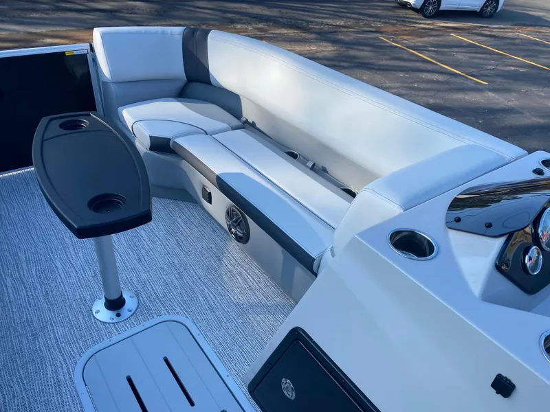 Slide: The Image of 2025 SunCatcher Select 322RC boat interior with sleek seating and table. - 11