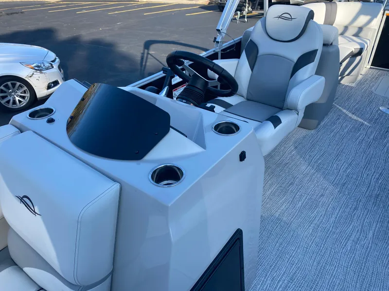 Slide: The Image of 2025 SunCatcher Select 322RC boat interior with steering console and seating. - 12