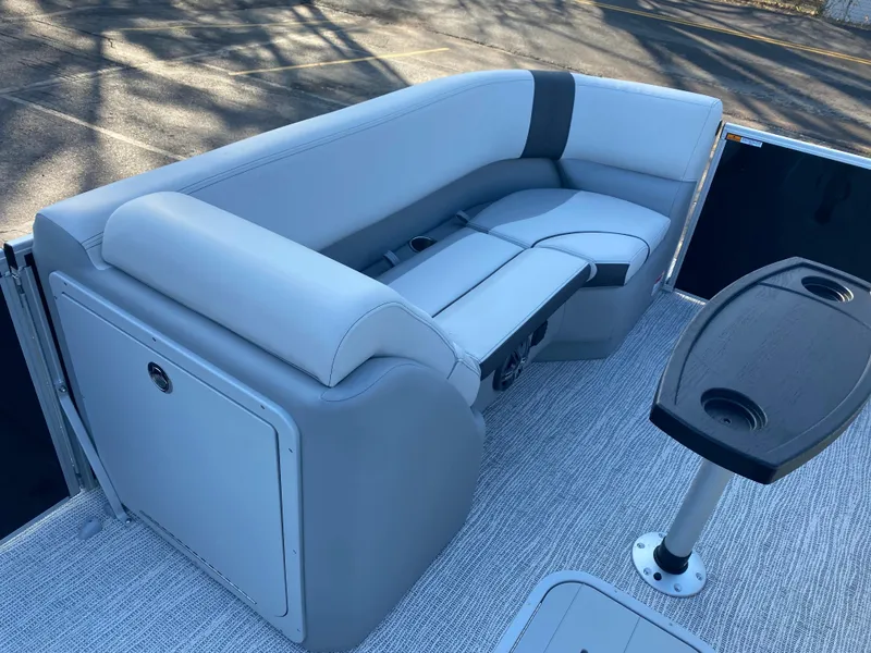 Slide: The Image of 2025 SunCatcher Select 322RC boat interior with gray seating and table. - 13