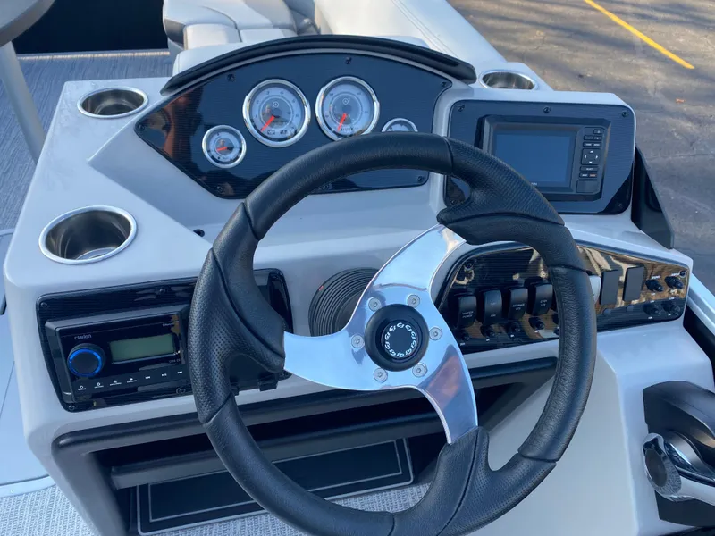 Slide: The Image of Steering console of 2025 SunCatcher Select 322RC boat with gauges and controls. - 25