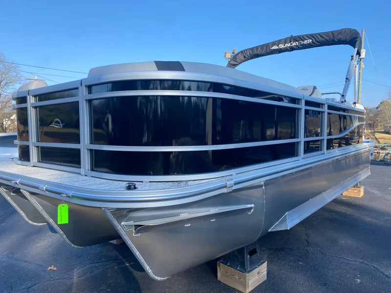Slide: The Image of 2025 SunCatcher Select 322RC pontoon boat on display, showcasing sleek design and modern features. - 3
