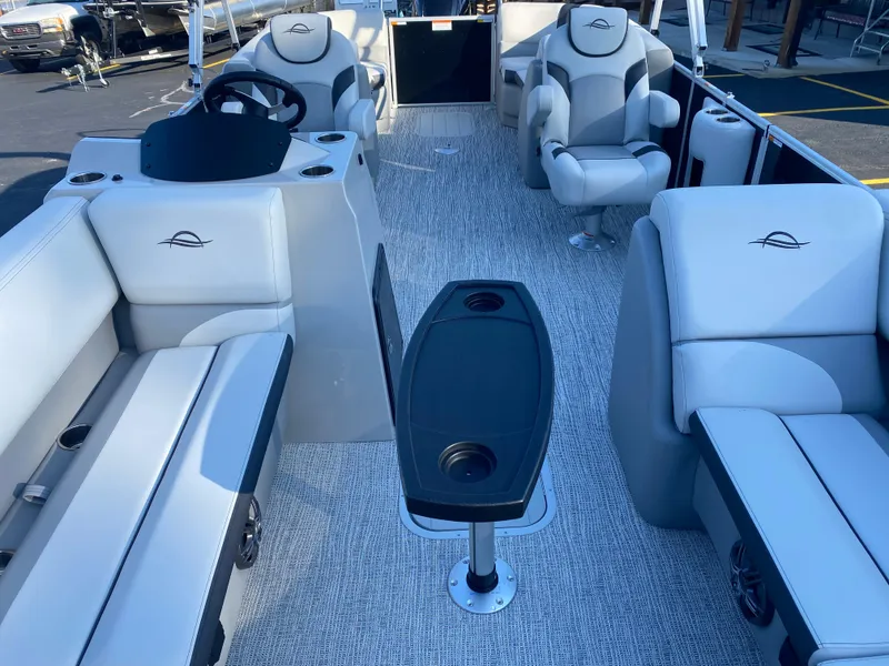 Slide: The Image of 2025 SunCatcher Select 322RC pontoon boat interior with plush seating and central table. - 8