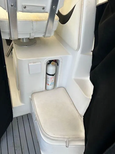 Slide: The Image of 2003 Seaswirl Striper 2601 Walkaround I/O interior with fire extinguisher storage. - 11