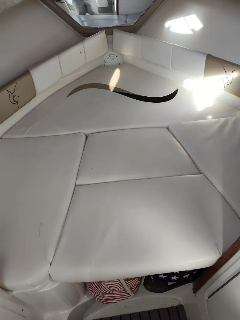 Slide: The Image of 2003 Seaswirl Striper 2601 Walkaround I/O cabin interior with cushioned seating. - 13