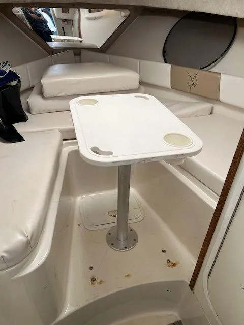 Slide: The Image of 2003 Seaswirl Striper 2601 Walkaround I/O cabin interior with table and seating. - 15