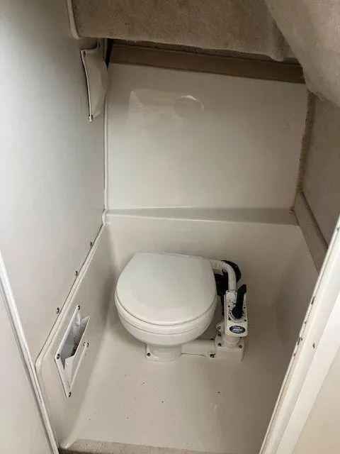 Slide: The Image of 2003 Seaswirl Striper 2601 Walkaround I/O boat interior with compact marine toilet. - 17