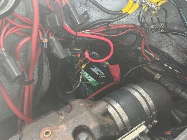 Slide: The Image of Engine compartment of 2003 Seaswirl Striper 2601 Walkaround I/O with visible battery and wiring. - 20