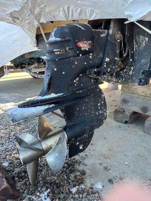 Slide: The Image of 2003 Seaswirl Striper 2601 Walkaround I/O boat propeller with visible wear and marine growth. - 23