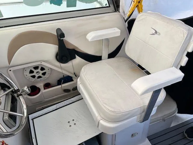 Slide: The Image of 2003 Seaswirl Striper 2601 Walkaround I/O helm seat with steering wheel and controls. - 8