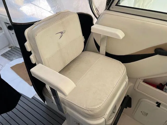 Slide: The Image of 2003 Seaswirl Striper 2601 Walkaround I/O boat seat, white upholstery, armrests, and logo detail. - 9