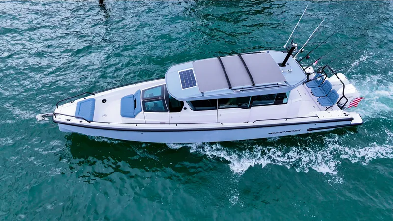 Slide: The Image of 2023 Axopar 37 XC CROSS CABIN cruising on open water, aerial view. - 1