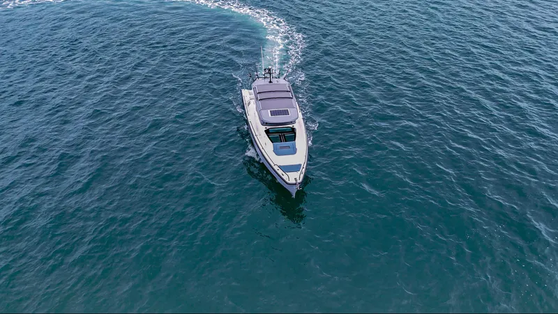 Slide: The Image of 2023 Axopar 37 XC CROSS CABIN cruising on open water. - 14