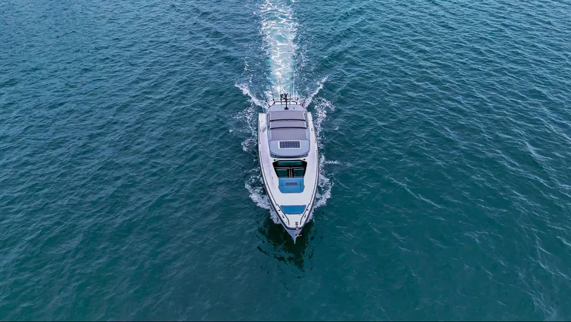 Slide: The Image of 2023 Axopar 37 XC CROSS CABIN cruising on open water, aerial view. - 15