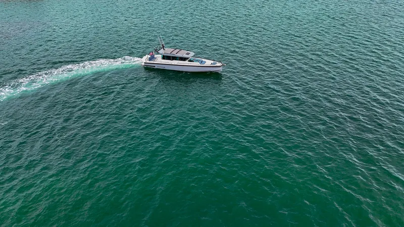 Slide: The Image of 2023 Axopar 37 XC CROSS CABIN cruising on open water. - 28