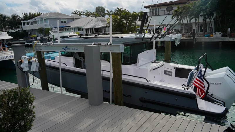 Slide: The Image of 2023 Axopar 37 XC CROSS CABIN docked by waterfront homes. - 29
