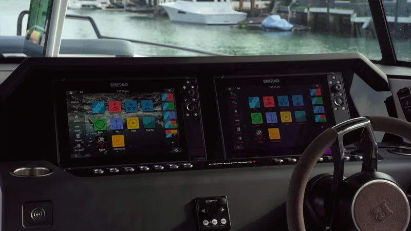 Slide: The Image of 2023 Axopar 37 XC CROSS CABIN dashboard with dual navigation screens. - 35