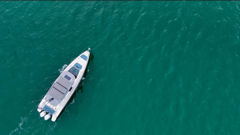 Slide: The Image of 2023 Axopar 37 XC CROSS CABIN cruising on open water, aerial view. - 4