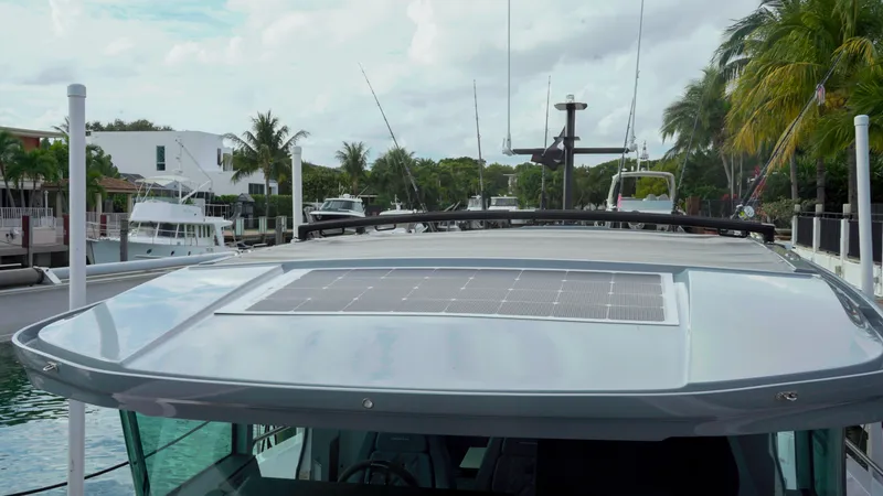 Slide: The Image of 2023 Axopar 37 XC CROSS CABIN with solar panel, docked in a tropical marina. - 44