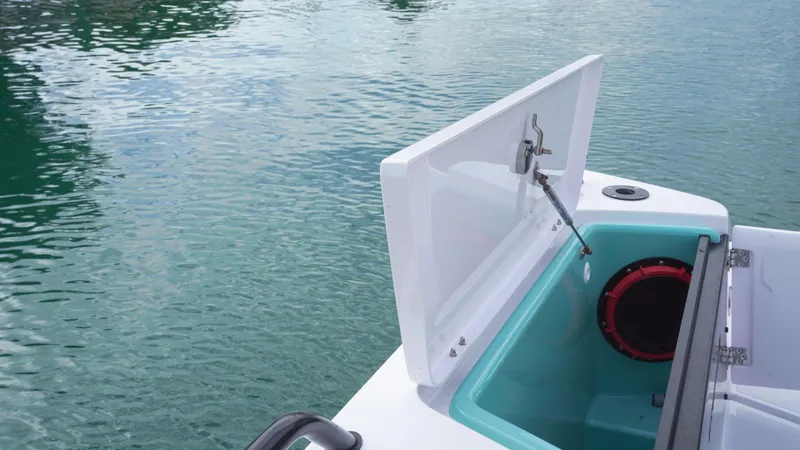 Slide: The Image of Open storage compartment on 2023 Axopar 37 XC CROSS CABIN boat by the water. - 46