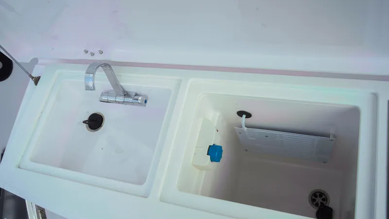 Slide: The Image of 2023 Axopar 37 XC CROSS CABIN sink and storage compartment. - 47