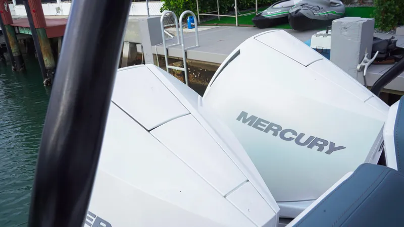 Slide: The Image of 2023 Axopar 37 XC CROSS CABIN with Mercury outboard engines docked by the water. - 48