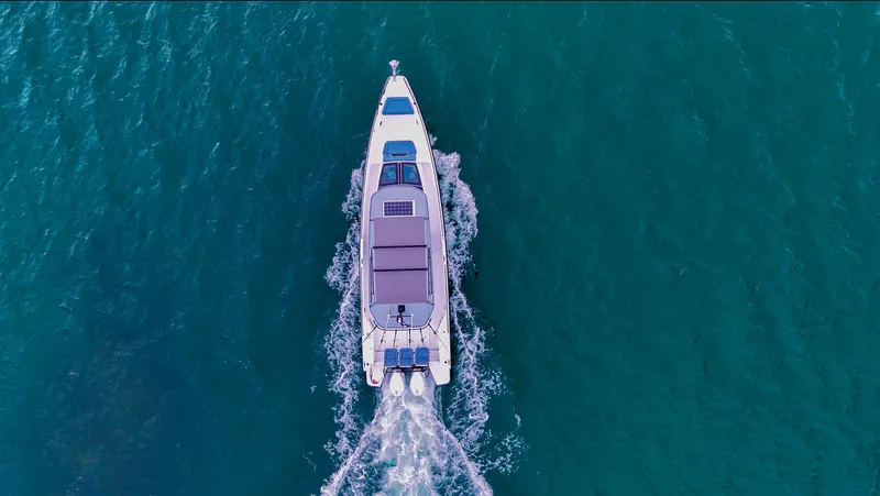 Slide: The Image of Aerial view of 2023 Axopar 37 XC CROSS CABIN cruising on blue water. - 5