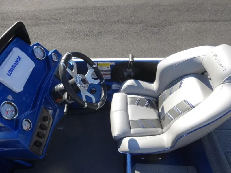 Slide: The Image of 2023 Nitro Z18 boat interior with steering wheel and cushioned seat. - 10