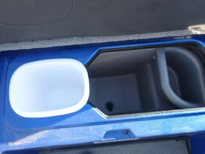 Slide: The Image of 2023 Nitro Z18 boat storage compartment with blue interior and white container. - 15