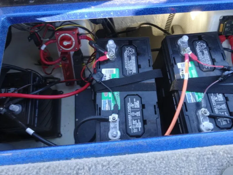 Slide: The Image of Battery compartment of a 2023 Nitro Z18 boat with wiring and connections. - 19