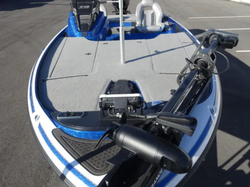 Slide: The Image of 2023 Nitro Z18 boat with trolling motor and seating, parked on pavement. - 3