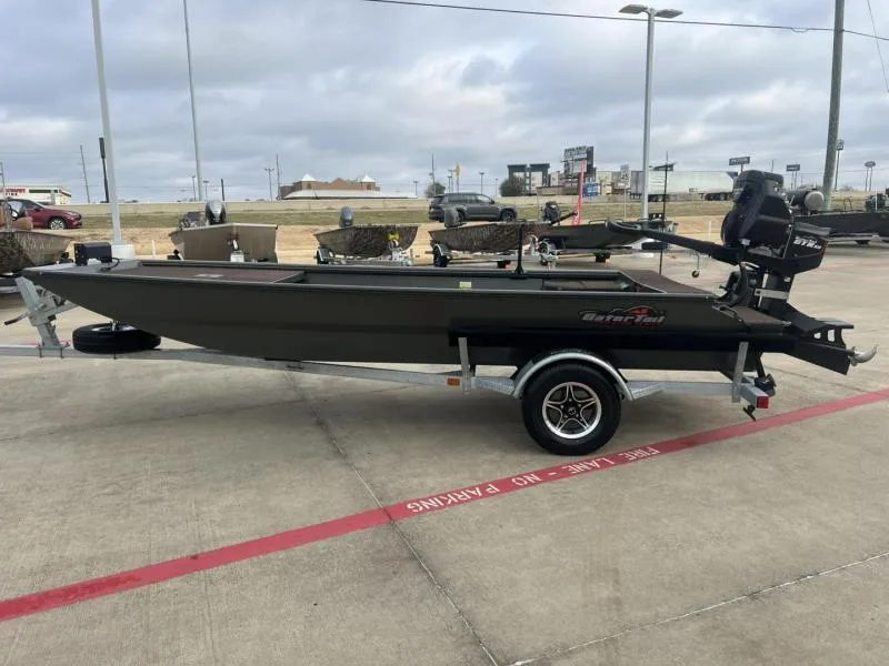 Slide: The Image of 2025 Gator Tail 17/48 Gator Series boat on trailer in parking lot. - 6