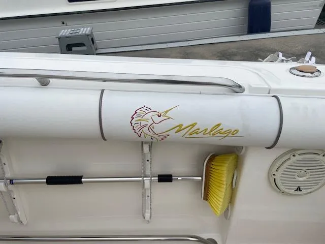 Slide: The Image of 2006 Marlago FS 35 Cuddy boat with logo and cleaning brush on deck. - 11