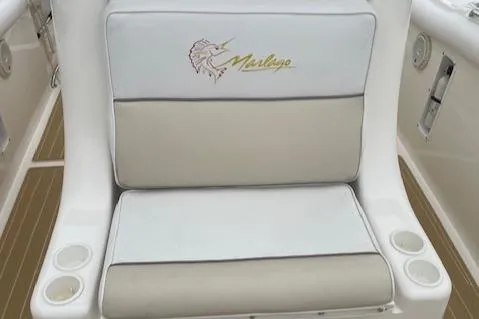 Slide: The Image of 2006 Marlago FS 35 Cuddy boat seat with logo and cup holders. - 12