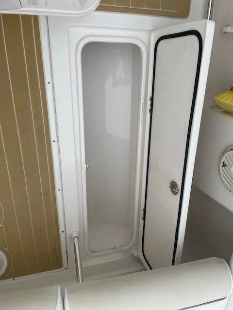 Slide: The Image of 2006 Marlago FS 35 Cuddy interior storage compartment with open door. - 16