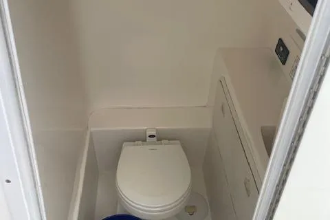 Slide: The Image of 2006 Marlago FS 35 Cuddy boat interior with compact marine toilet. - 17