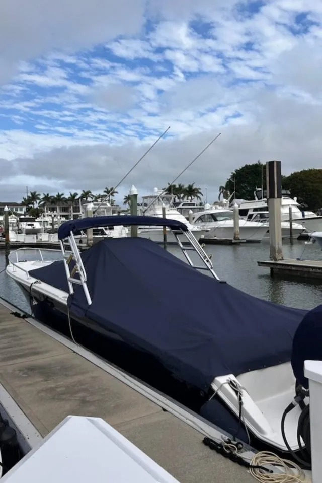 Slide: The Image of 2006 Marlago FS 35 Cuddy boat docked at a marina under a cloudy sky. - 4