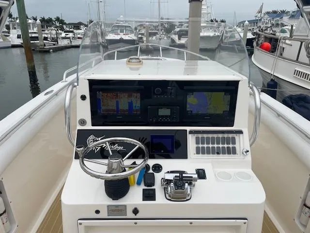 Slide: The Image of 2006 Marlago FS 35 Cuddy boat dashboard with navigation equipment at marina. - 8