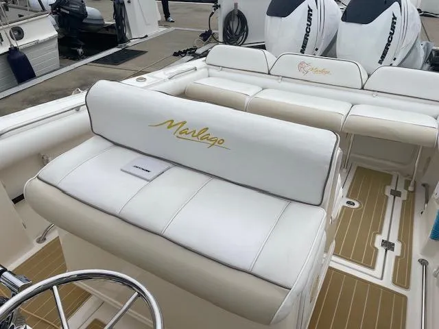 Slide: The Image of 2006 Marlago FS 35 Cuddy boat interior with white seating and Mercury engines. - 9