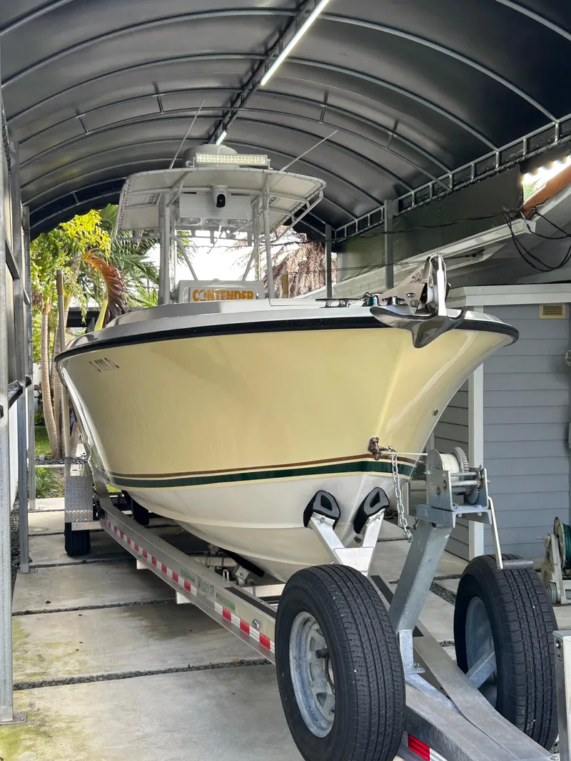 Slide: The Image of 2001 Contender 27' cuddy boat on trailer in covered storage. - 16