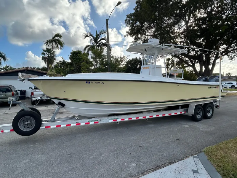 Slide: The Image of 2001 Contender 27' cuddy boat on trailer, parked outdoors. - 4