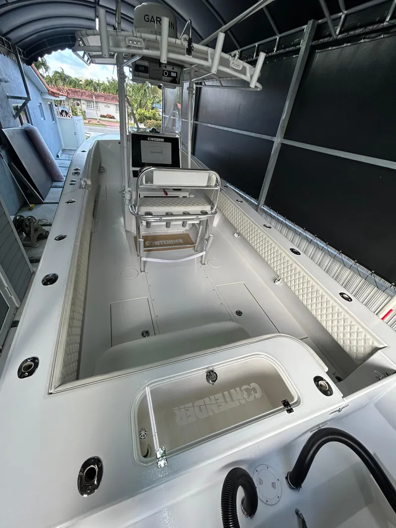 Slide: The Image of 2001 Contender 27' cuddy boat interior, featuring spacious deck and seating. - 5
