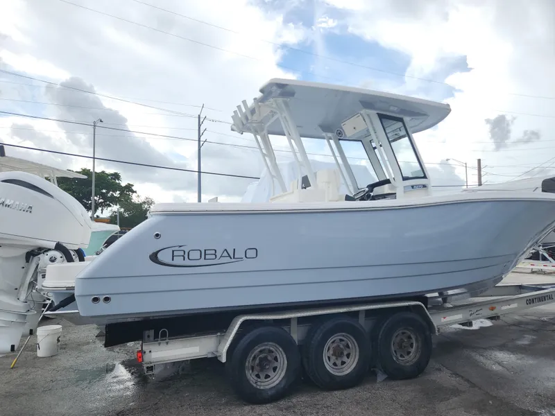 Slide: The Image of 2025 Robalo R270 Center Console boat on a trailer, side view. - 10