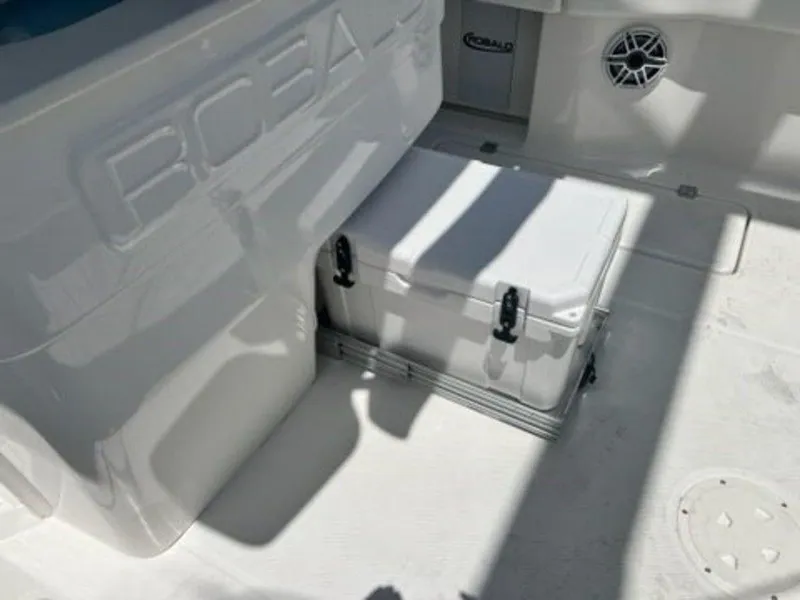 Slide: The Image of 2025 Robalo R270 Center Console interior with storage compartment and speaker. - 17