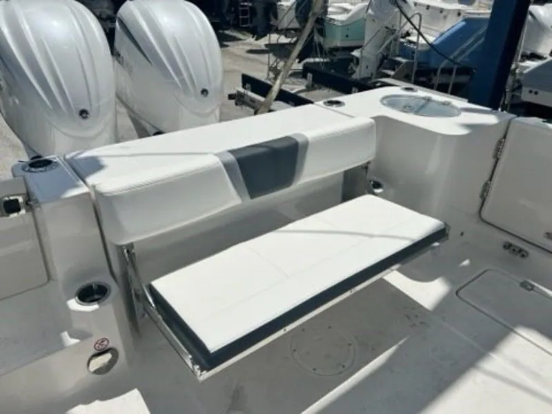 Slide: The Image of 2025 Robalo R270 Center Console boat with foldable seating and dual outboard engines. - 18