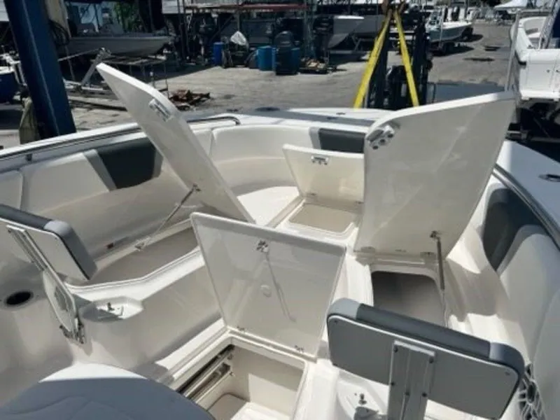 Slide: The Image of 2025 Robalo R270 Center Console boat with open storage compartments. - 19
