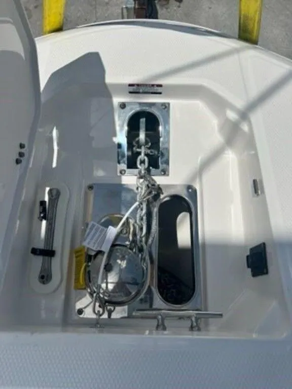 Slide: The Image of 2025 Robalo R270 Center Console anchor compartment with chain and winch. - 20
