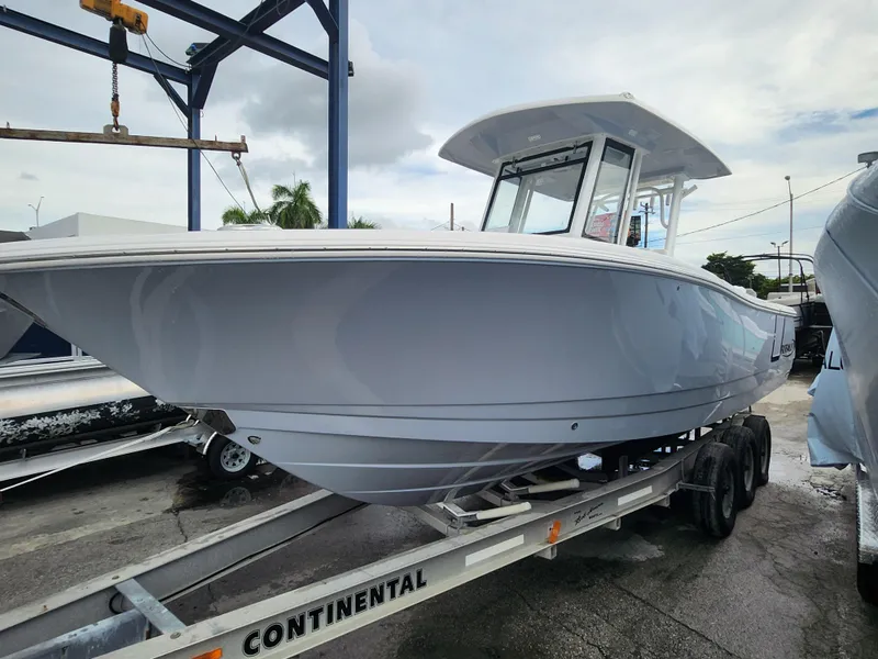 Slide: The Image of 2025 Robalo R270 Center Console boat on trailer, displayed outdoors. - 22