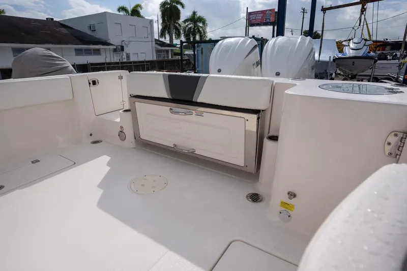 Slide: The Image of 2025 Robalo R270 Center Console boat interior with storage compartment and dual engines. - 5