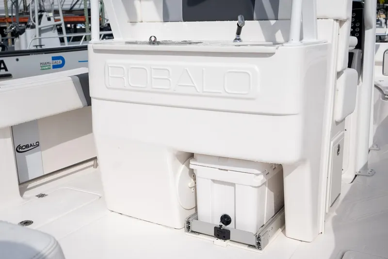 Slide: The Image of 2025 Robalo R270 Center Console boat interior with storage compartment and sink. - 7